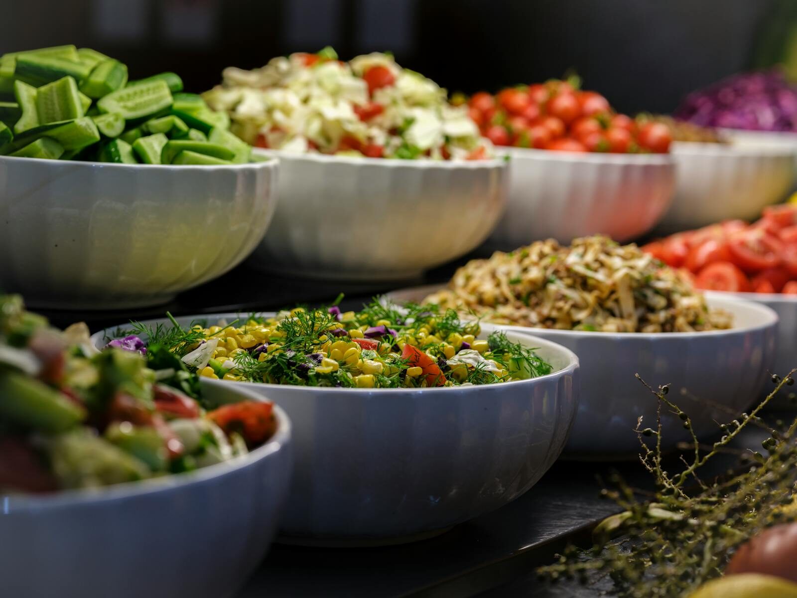 A colorful assortment of fresh salads and vegetables in ceramic bowls. Perfect for healthy food photography.